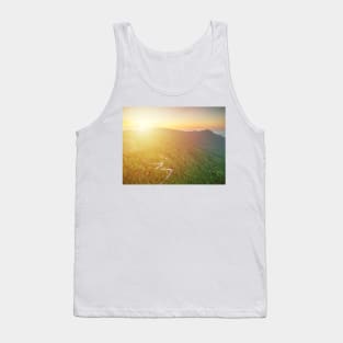 Aerial view of curvy mountain road through a jungle ay sunset Tank Top